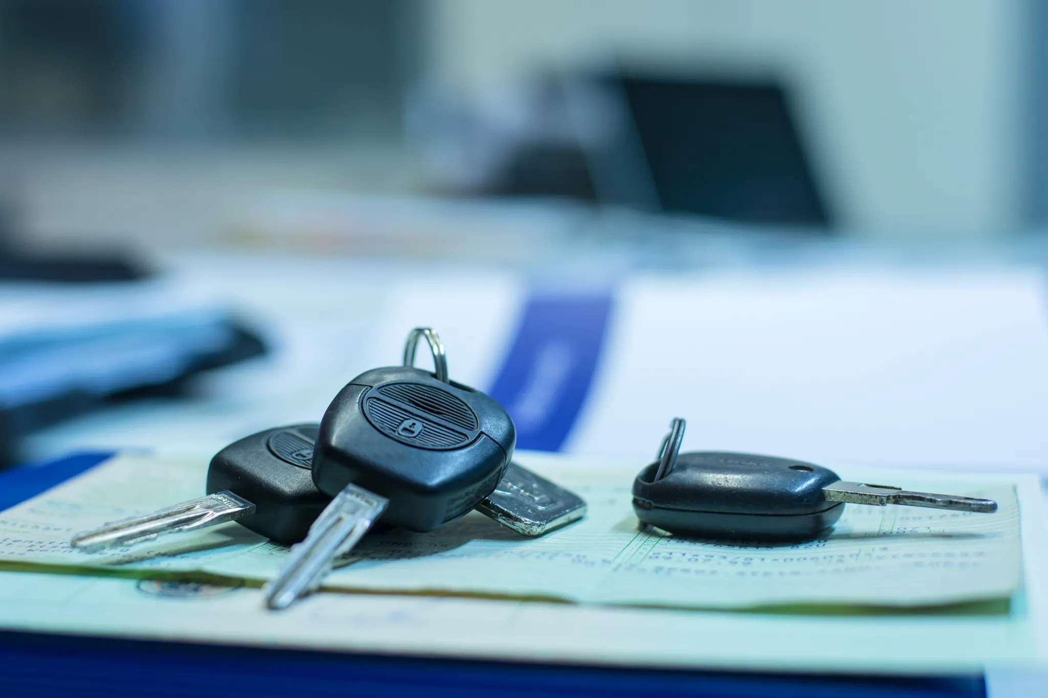 Typschlüsselnummer, Drei Autoschlüssel liegen auf Dokumenten